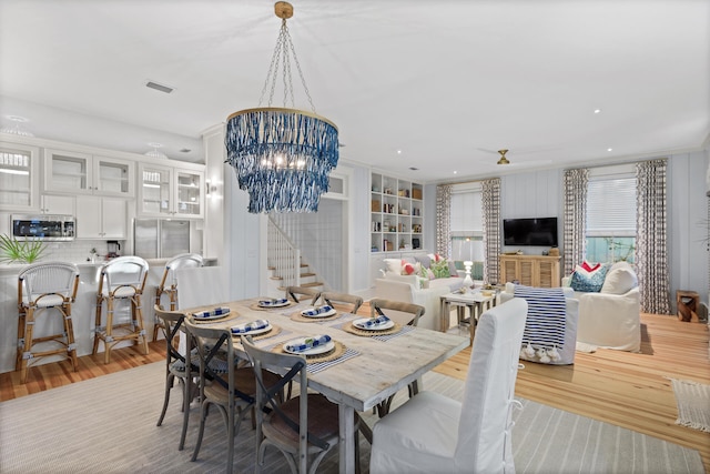 dining room featuring light hardwood / wood-style floors and an inviting chandelier