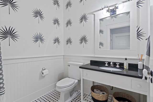 bathroom with toilet, tile flooring, and sink