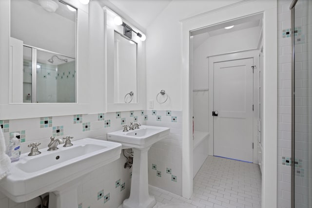 bathroom featuring tasteful backsplash, tile flooring, tile walls, and sink