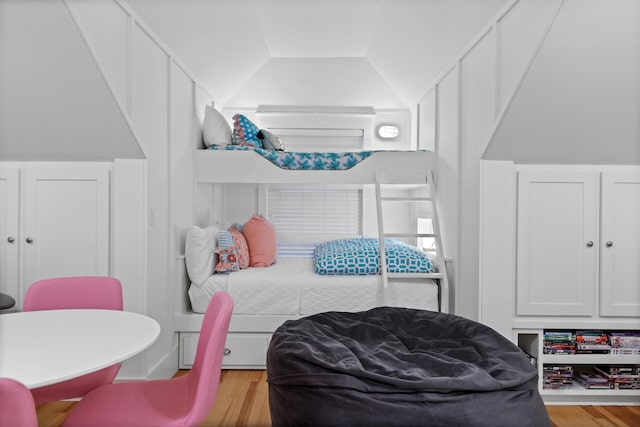 bedroom featuring lofted ceiling and light hardwood / wood-style floors