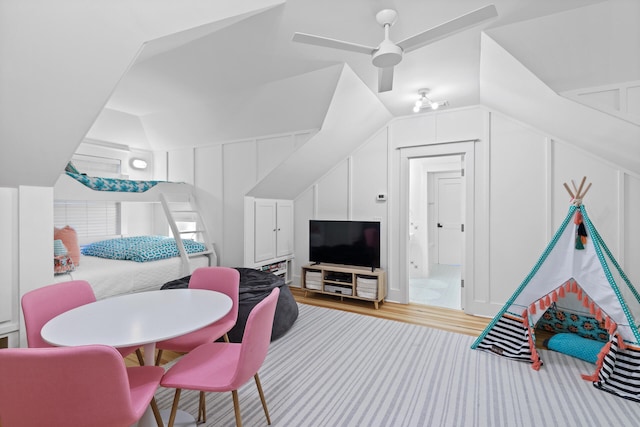 interior space featuring lofted ceiling, ceiling fan, and light wood-type flooring