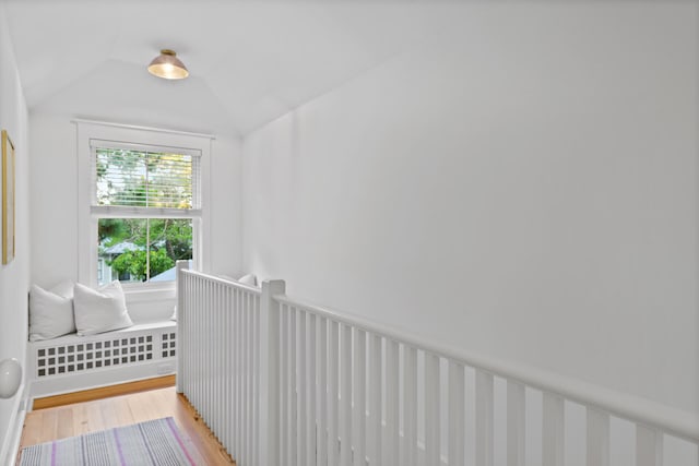 interior space with light hardwood / wood-style floors and lofted ceiling