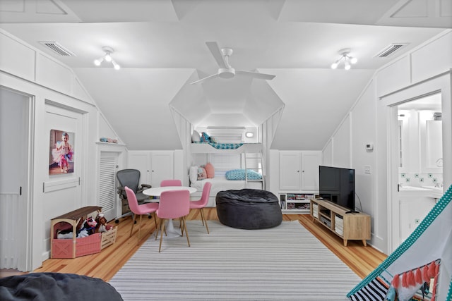 interior space featuring light hardwood / wood-style floors, ceiling fan, and vaulted ceiling