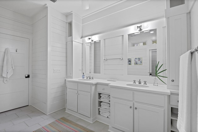 bathroom with dual bowl vanity and tile floors