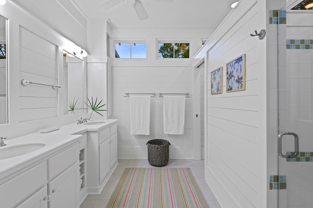 bathroom featuring large vanity, ceiling fan, tile flooring, an enclosed shower, and double sink