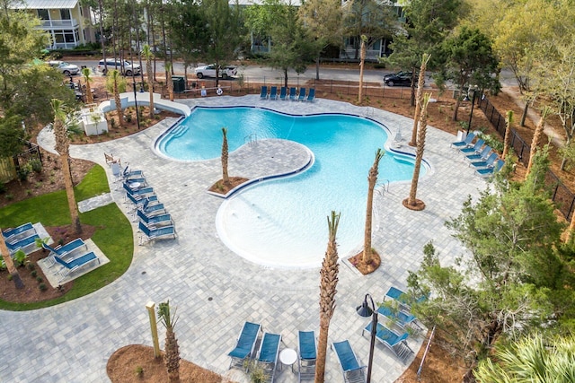 view of swimming pool featuring a water slide and a patio