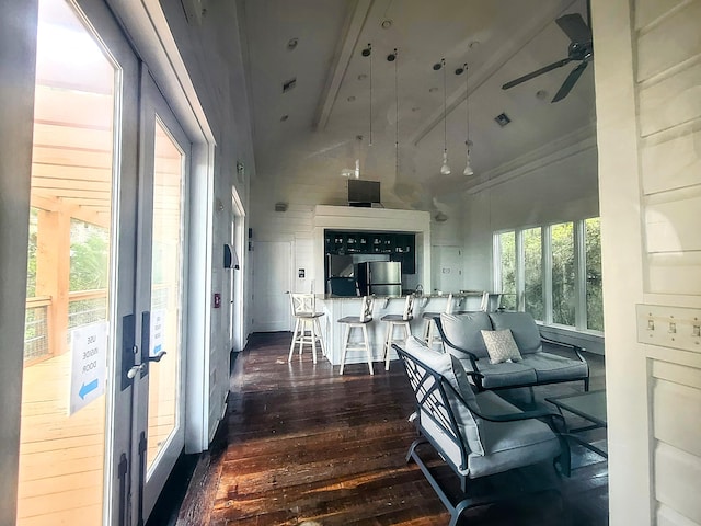 living room with beam ceiling, dark hardwood / wood-style flooring, high vaulted ceiling, and ceiling fan