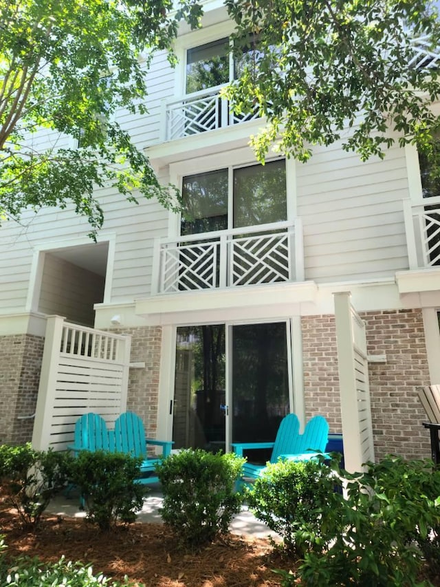 back of house featuring a balcony