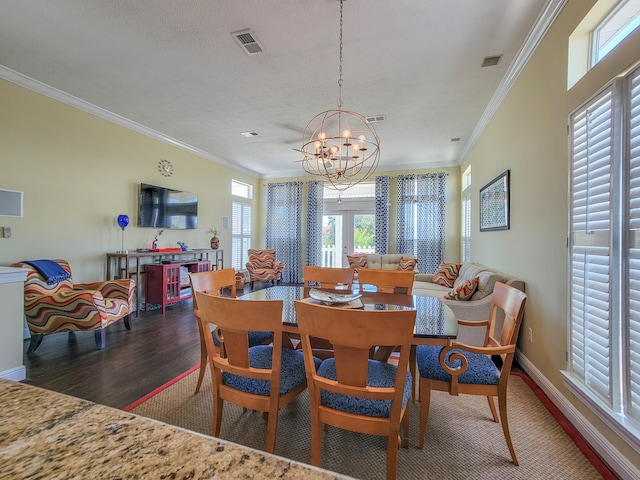 dining area with a chandelier, crown molding, and dark hardwood / wood-style floors