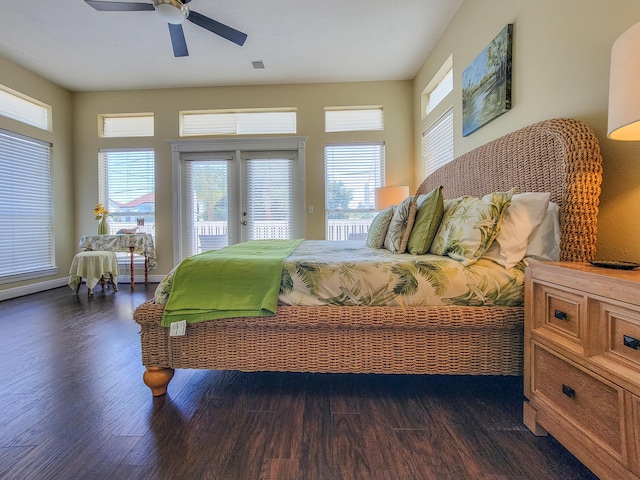 bedroom with dark hardwood / wood-style flooring, ceiling fan, and access to exterior