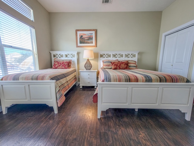 bedroom with a closet and dark hardwood / wood-style floors