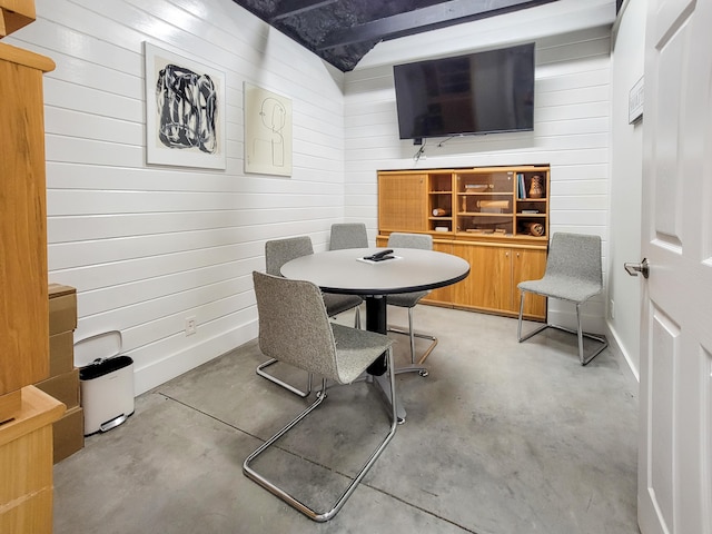 dining room featuring wooden walls