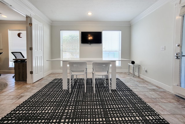 tiled dining room featuring ornamental molding and a healthy amount of sunlight