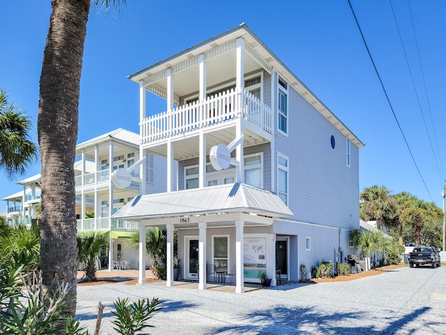 back of house featuring a balcony