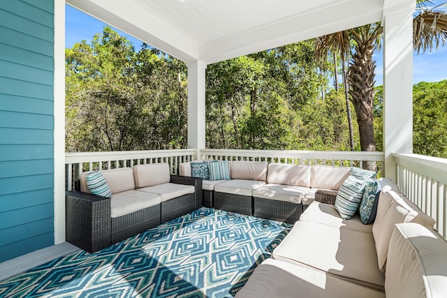 wooden terrace with an outdoor hangout area