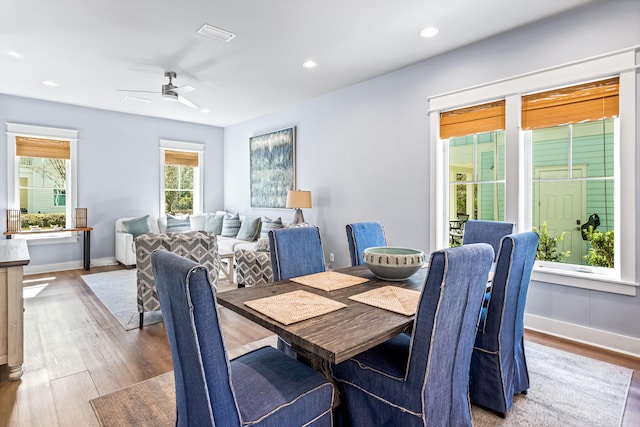 dining space with hardwood / wood-style flooring and ceiling fan