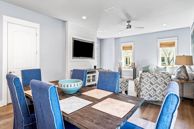 dining space with ceiling fan and hardwood / wood-style flooring