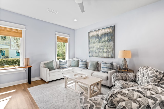 living room with light wood-type flooring and ceiling fan