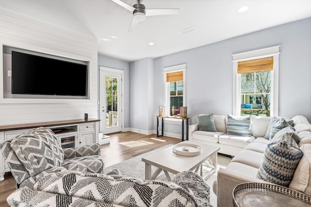 living room featuring ceiling fan and hardwood / wood-style flooring