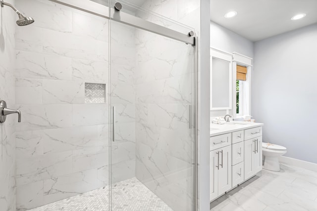 bathroom with vanity, toilet, and an enclosed shower