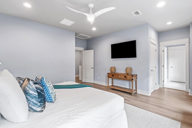 bedroom with a closet, ceiling fan, and light hardwood / wood-style flooring