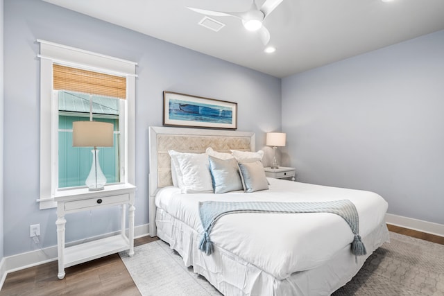 bedroom with ceiling fan and wood-type flooring