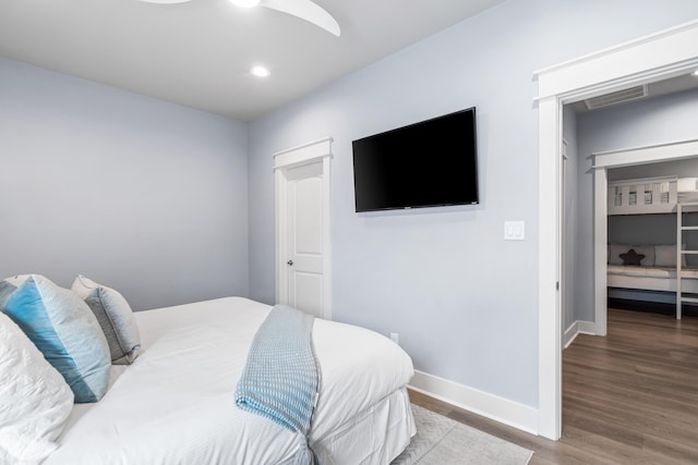 bedroom with hardwood / wood-style floors, ceiling fan, and a closet