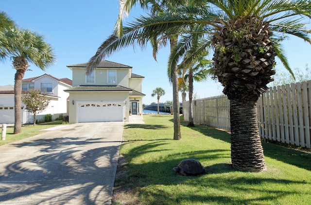 view of front of property featuring a garage and a front lawn