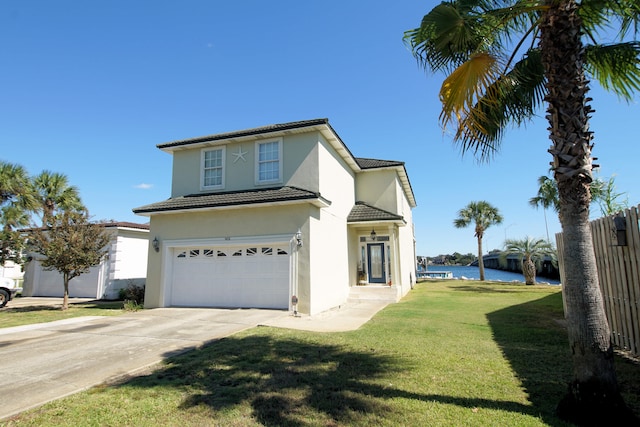 view of front of property featuring a water view, a front lawn, and a garage