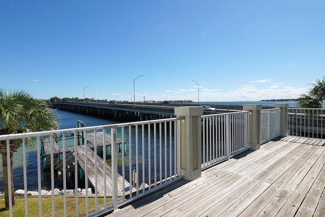 wooden terrace featuring a water view