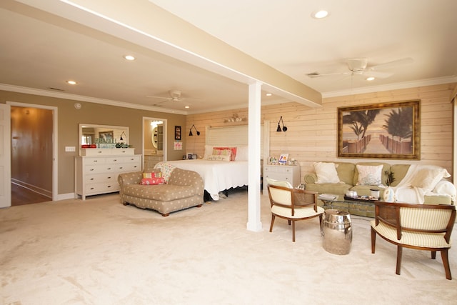 carpeted bedroom with wood walls, ceiling fan, beam ceiling, and ornamental molding