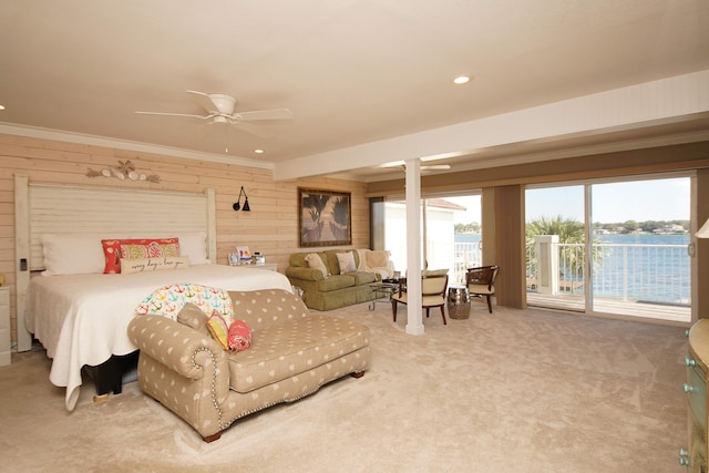 carpeted bedroom featuring ornate columns, ceiling fan, crown molding, and access to outside