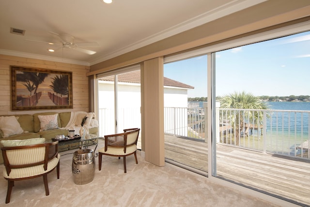 sunroom / solarium featuring a water view and ceiling fan