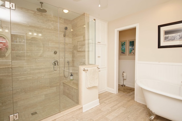 bathroom with hardwood / wood-style floors and plus walk in shower