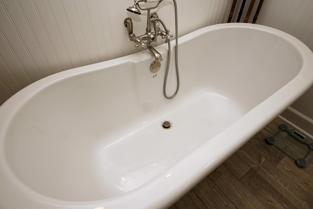 details featuring hardwood / wood-style flooring and a washtub