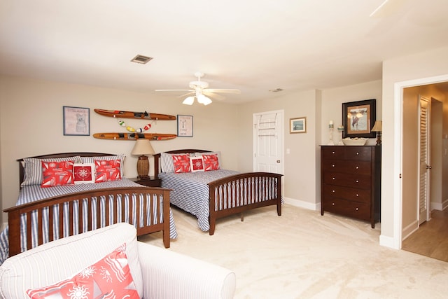 bedroom with light colored carpet and ceiling fan