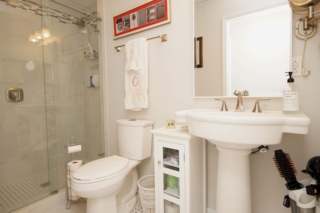 bathroom featuring a shower with shower door, toilet, and tile flooring