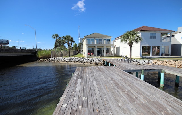 view of dock featuring a balcony and a water view