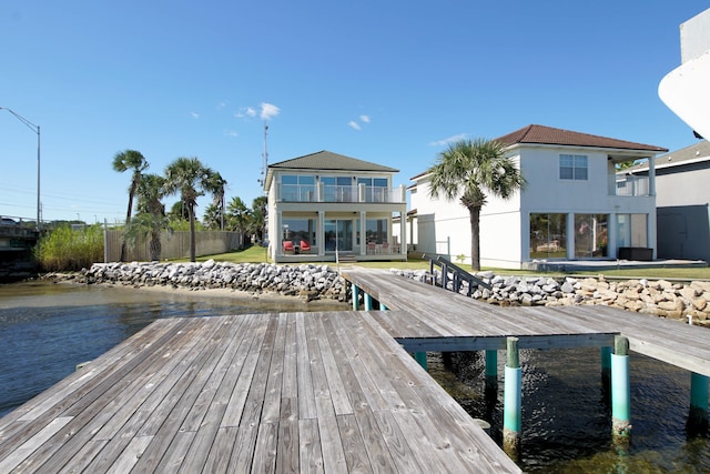 view of dock featuring a deck and a balcony