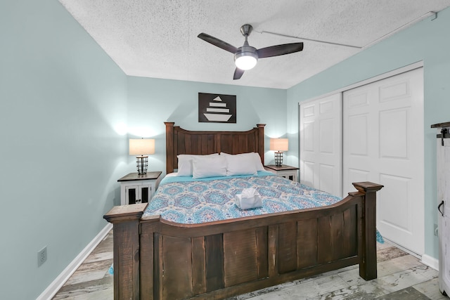 bedroom with a closet, ceiling fan, light wood-type flooring, and a textured ceiling