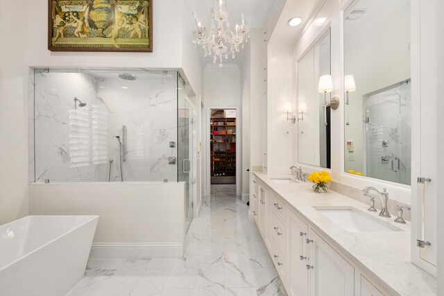 bathroom featuring shower with separate bathtub, a notable chandelier, and vanity