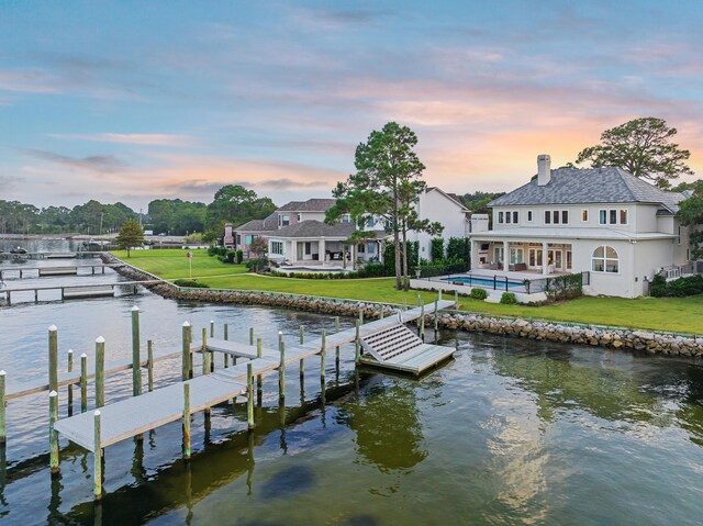 dock area featuring a water view and a yard