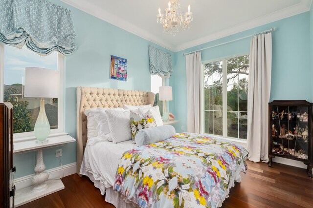 bedroom with crown molding, an inviting chandelier, and dark hardwood / wood-style floors