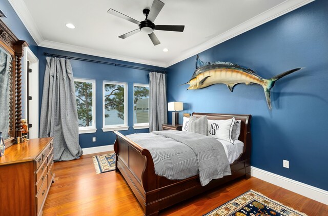 bedroom featuring crown molding, ceiling fan, and hardwood / wood-style floors