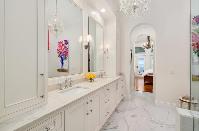 bathroom featuring a chandelier and vanity