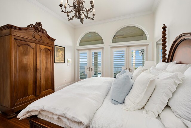 bedroom with crown molding, hardwood / wood-style floors, a chandelier, and access to outside