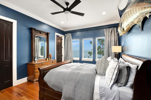 bedroom featuring crown molding, ceiling fan, and hardwood / wood-style flooring