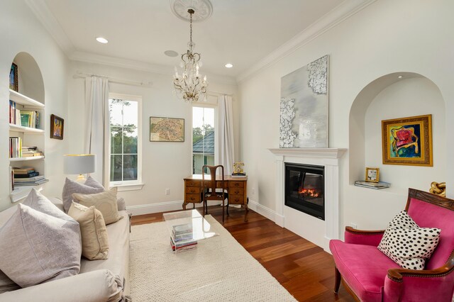 living room featuring ornamental molding, dark wood-type flooring, and a notable chandelier