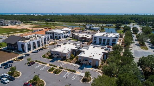 drone / aerial view featuring a water view and a view of trees