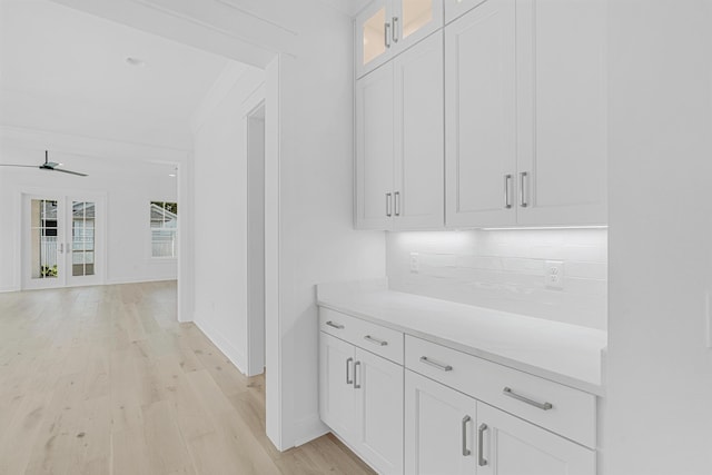 hallway with light wood-type flooring and baseboards